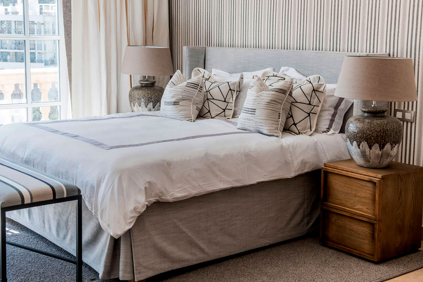 Elegant bedroom furniture and cozy bedding.